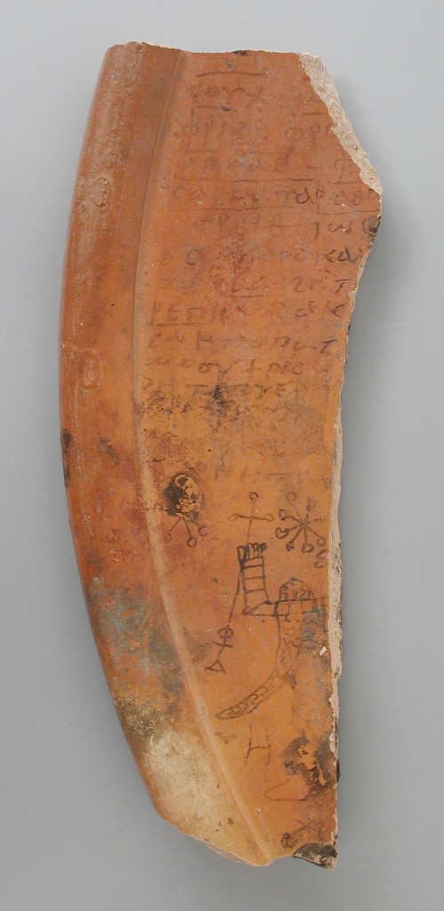 A broken fragment of red pottery with Coptic writing painted on it, as well as a number of small drawings, especially star-like elements.