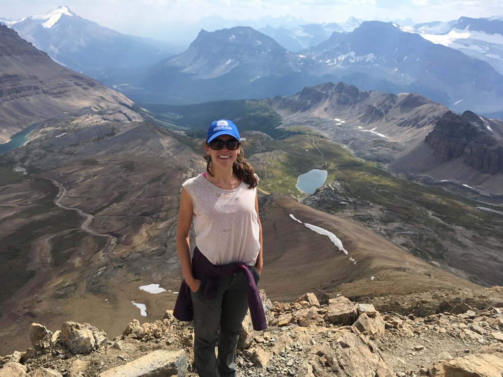 Image of Dr. Jessica Lamont on top of a mountain. 